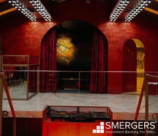 Acquire a high-end bar/club with unique cocktails and canapes in a bustling area.