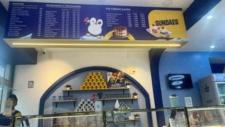 Ice cream parlour in Bengaluru with seating, steady walk-ins, and operational setup offered for sale.