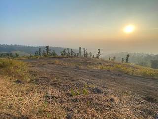 Dehradun-based hill-view land parcel ideal for hospitality or farmhouse use, available for outright sale.