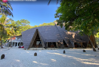 Exclusive remote Indonesian island resort offering beachfront villas and diving experiences for international travelers.