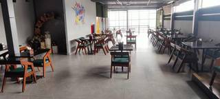 Majority ownership in cafe serving multiple cuisines and seeking to expand menu with alcoholic beverages.