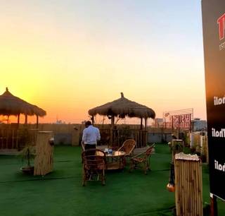 Restaurant specializing in Champaran cuisine with an open rooftop setup.
