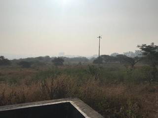 A commercial plot of 2 acres on the hilltop area in Pune, surrounded by forest.
