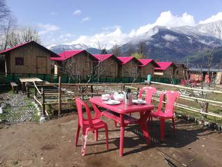Manali based base camp with 8 bamboo huts and garden offering amazing experience of the Himalayas.