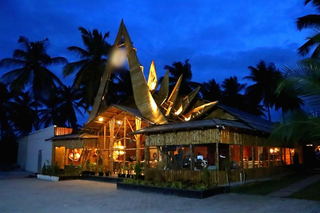 Bamboo-themed multi-cuisine restaurant near Mysore-Bangalore highway for sale, with high ratings and multiple revenue sources.