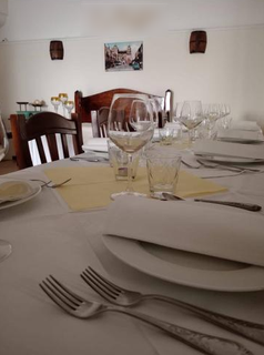 Family-owned Puglian restaurant serving authentic homemade cuisine in a scenic Italian village, available for acquisition.