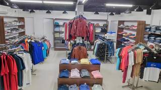 Men's apparel shop for sale with stock, shelf, stand, and other items.