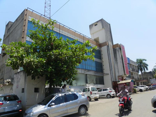 Acquire a prime commercial property with 22 shops and 2 large spaces at discounted value.