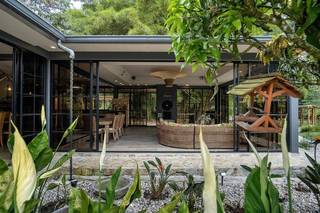 Ecotourism boutique hotel for sale with 3 suites, riverfront, expansion potential and 85% occupancy.