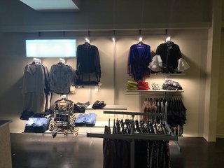 Provides retail store space to apparel brands with clothing rack fixtures illuminated with LED rods.