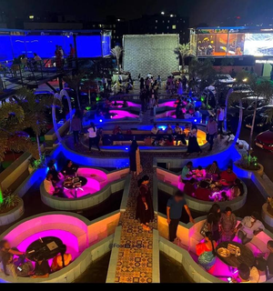 Drive-in restaurant with multiple food stalls and entertainment that receives 1,500+ customers daily for sale.