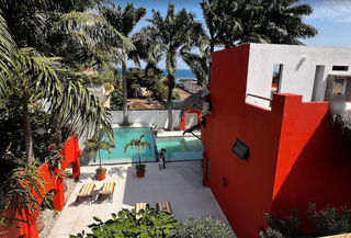 For Sale: Boutique beachfront hotel in Puerto López featuring 10 rooms and tropical gardens.