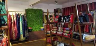Women's apparel store with enough space for photography and makeup studio, serving 100 monthly customers.