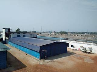 Commercial land of 100,000 Sq Ft with a boundary wall and 7 constructed sheds.